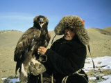 A Kazakh Eagle Hunter Poses with His Eagle on a Plain in Kazakhstan