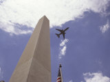 Plane Flying above Washington Monument and United States Flag