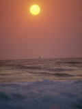 Surf Breaks on a Beach at Sunset
