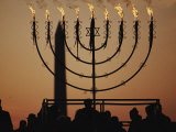 Silhouetted Worshippers Stand Before a Large Menorah Near the Washington Monument