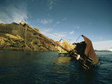 A Partially Submerged Shipwreck Along a Rocky Shore