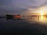 Twilight View of a Ship at Anchor in Still Water at Low Tide