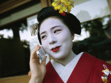 A Kimono-Clad Geisha Talks on a Cell Phone