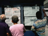 Men Reading the Daily Newspaper at an Inner City Kiosk  Havana  Cuba