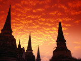 Sun Sets Over the Chedis (Buddhist Stupas) of Wat Phra Si Sanphet  Ayuthaya  Thailand