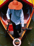 Helmsman Manoeuvres Sampan or Ferry on Sarawak River  Kuching  Sarawak  Malaysia