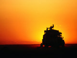 Tourist Watching Sunset on Roof of Safari Vehicle  Central Kalahari Game Reserve  Botswana