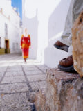 Woman Approaching Man Sitting on Step in Lane  Nerja  Spain