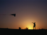 Boy Flying Kite at Sunset  England  United Kingdom