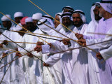 Men Performing Traditional Dance with Sticks  Abu Dhabi  United Arab Emirates