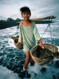 A Girl Gathers Salt Water in Lontar Leaf Buckets for Salt Making  Kusamba  Indonesia