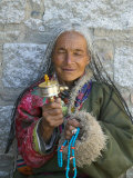 Tibetan Woman Holding Praying Wheel in Sakya Monastery  Tibet  China