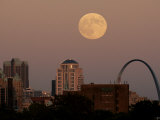 A Full Moon Rises Behind Downtown Saint Louis Buildings and the Gateway Arch Friday