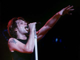 Jon Bon Jovi Raises His Hand to the Audience While Singing at One of Their Concerts