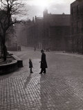 Policeman Talking to Lost Child on a Cobbled Street in Edinburgh  Scotland