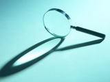Magnifying Glass on Its Side with Shadow in Blue Light