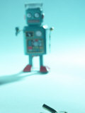 Gray Toy Plastic Robot Walking Towards Key Mechanism