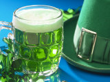 Mug of Green Beer Beside Green St Patrick's Day Decorations