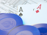 Blue Gambling Chips and Two Ace Cards on Stock Market Report