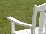 White Wooden Chair Against Green Grass