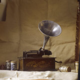 An Early Edison Phonograph Using Grooved Wax Cylinders Shown Beside the Instrument