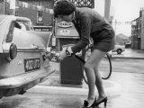 The Modern Female Petrol Pump Operator Refuelling a Car in Her Mini Skirt