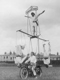 Motorcycle Acrobat Troupe Called "The Promenade Percies" Practise Their Act Involving Balance