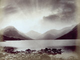 A Lake Surrounded by Mountains in a Stormy Dawn