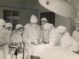 Group of Student Nurses in Theatre Observing a Surgeon Performing an Operation