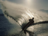 Waterskier Silhouetted with Sun Shining Through Water
