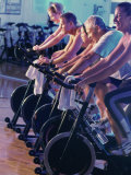 Group of People on Exercise Bikes in a Health Club