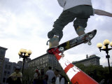 Skateboarder in Midair Knocking Over a Cone