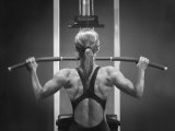 Rear View of a Woman Exercising on a Machine