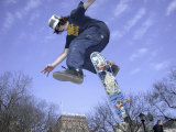 Skateboarder in Midair Doing a Trick