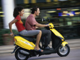 Young Couple Riding on a Motor Scooter