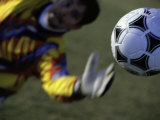 Goalie Attempting to Stop a Soccer Ball