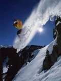 Airborne Snowboarder with Sunburst