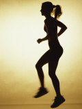 Silhouette of a Young Woman Exercising