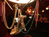 A Woman's High Heeled Shoe Hangs with Some Mardi Gras Beads
