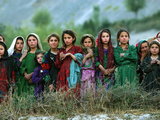 Local Girls Look at a UN Workers Unloading Ballot Kits from a UN Helicopter