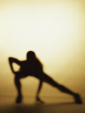 Silhouette of a Woman Exercising