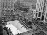 With the Famed Rockefeller Center Christmas Tree Rising Above Them  Skaters Glide on the Ice