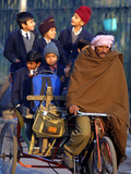 Indian Children Ride to School on the Back of a Cycle Rickshaw