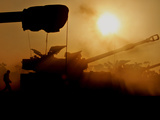 An Israeli Soldier Runs to Reload an Israeli Mobile Artillery Piece
