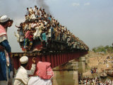 Hundreds of Muslim Pilgrims Ride on a Train Passing on a Bridge at Gazipur