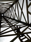A Reenactor is Silhouetted Inside a Replica of the Spindletop Oil Derrick