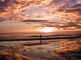 A Young Boy Takes an Early Morning Jog as the Sun Rises Along China Beach