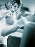 Young Woman Exercising in a Gym