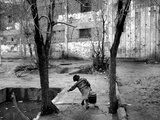 A Young Afghan Girl Carries Water from a Well to Her Family