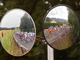 Mirrors at a T-Junction Reflect Riders During the 18th Stage of the Tour De France